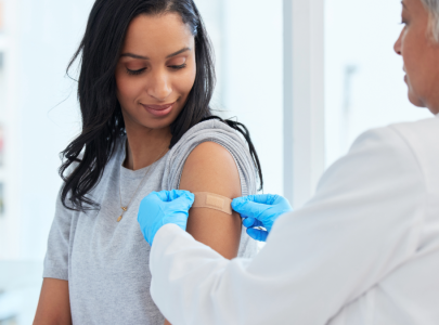 Pharmacist attends to a patient after a successful vaccination.